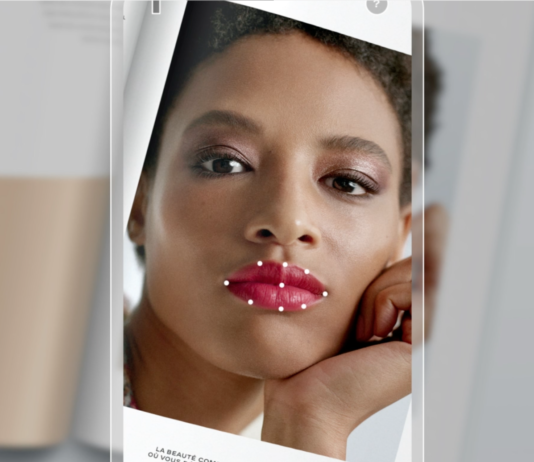 site-industries-cosmetiques A woman with lipstick on her face using Lipscanner, Chanel's first color reader.