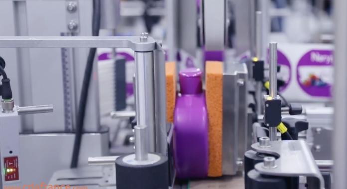 site-industries-cosmetiques A machine in a factory celebrating its 30th anniversary with a purple ball on top.