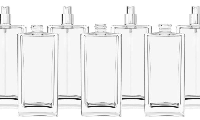 site-industries-cosmetiques Six clear glass bottles.