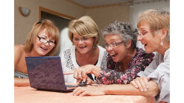 site-industries-cosmetiques A group of elderly women examining a laptop computer while considering hormonal evolution in women for cosmetics.