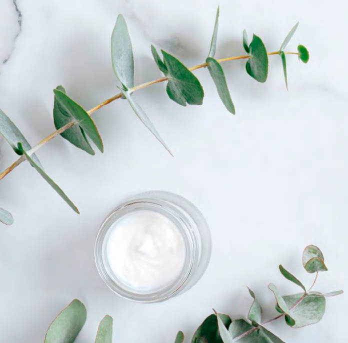 site-industries-cosmetiques A jar of Eucalyptus cream on a marble table at Gattefossé.