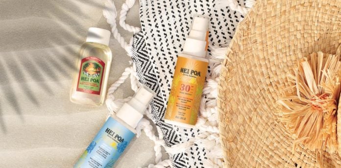 site-industries-cosmetiques Une bouteille de crème solaire et un chapeau de paille sur une plage de Tahiti.