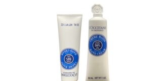 site-industries-cosmetiques Un tube de crème pour les mains l'occitane avec un tube bleu.