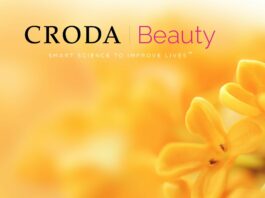 site-industries-cosmetiques 克罗达美容公司（Croda Beauty）的一则生动广告，以橙色花朵特写为特色，背景效果模糊，文字 "克罗达美容公司，以智能科学改善生活"，现在包括 Phytess。