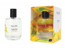 site-industries-cosmetiques 卢龙 "terre d'Oc "淡香水瓶的图片，其包装色彩艳丽，采用黄色、绿色和橙色的抽象图案，充满活力。环保设计的瓶身和包装盒上都自豪地标明 "法国制造"。