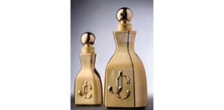site-industries-cosmetiques Two perfume bottles with a metallic gold finish, rounded cap and embossed Prad luxury brand logo on the front. This duo of new fragrances is elegantly presented against a neutral gray background.