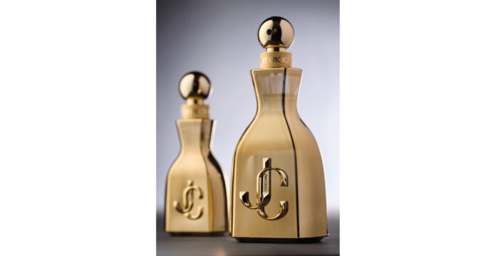 site-industries-cosmetiques Two perfume bottles with a metallic gold finish, rounded cap and embossed Prad luxury brand logo on the front. This duo of new fragrances is elegantly presented against a neutral gray background.