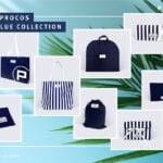 site-industries-cosmetics Presentation of navy blue and white packaging items, including tote bags, pouches, a garment bag and boxes from the Procos Blue Collection Brouillon auto. The background features a light blue gradient with palm leaf shadows.