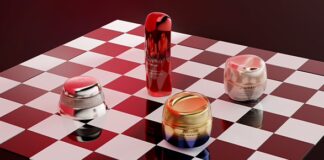 site-industries-cosmetics 四个资生堂护肤品容器，包括罐子和一个大瓶子，在壮观的灯光下，摆放在红白相间的棋盘格表面上，体现了资生堂在美容领域创新的 2030 年中期战略。.