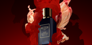site-industries-cosmetiques 一个深蓝色香水瓶，标有 "Ex Nihilo Paris Fleur Narcotique "字样，金色瓶盖，周围是半透明的红色和粉红色图形，暗红色背景。.