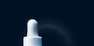 site-industries-cosmetiques 一个蓝色的罗氏-宝诗 Hyalu B5 精华素瓶子，旁边是一个滴管，末端有一滴液体，背景是深蓝色的圆点图案。.