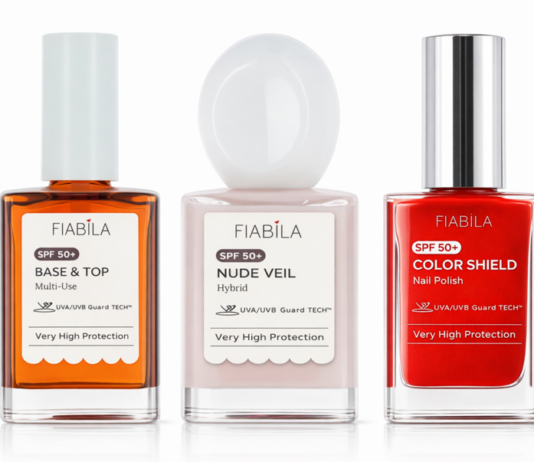 site-industries-cosmetiques 三瓶 Fiabila 指甲油并排摆放着：Base & Top（琥珀色）、Nude Veil Hybrid（浅粉色）和 Color Shield Nail Polish（红色）。每个标签上都写着 "SPF 50+"和 "极高防护"。.