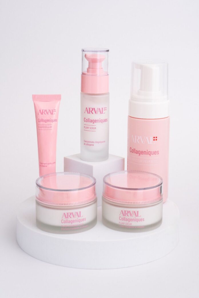 site-industries-cosmetiques 在纯白背景的白色圆形展示架上摆放着五件粉色和白色的 Arval Collageniques 护肤产品，包括两个罐子、一个泵瓶、一个管子和一个泡沫分配器。.