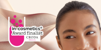 site-industries-cosmetiques 一位皮肤光洁、富有层次感的女士微笑着看向一旁。叠加的文字写着："in-cosmetics Award finalist CRODA Beauty"。背景是抽象的粉红色形状。.