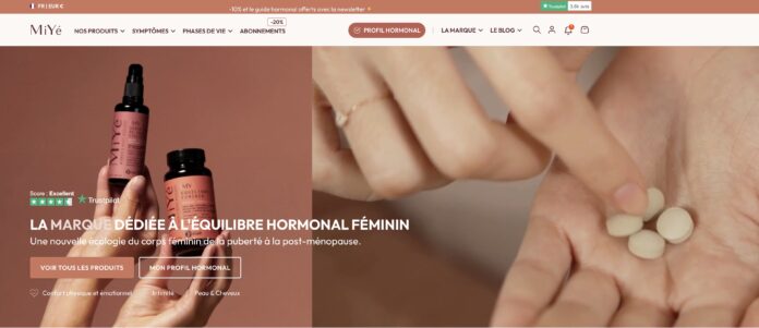 cosmetics-industry-website Close-up of hands holding a dropper bottle labeled «Miyé» and two beige tablets, with text in French introducing a brand dedicated to women’s hormonal balance, as it appears on the website’s homepage.